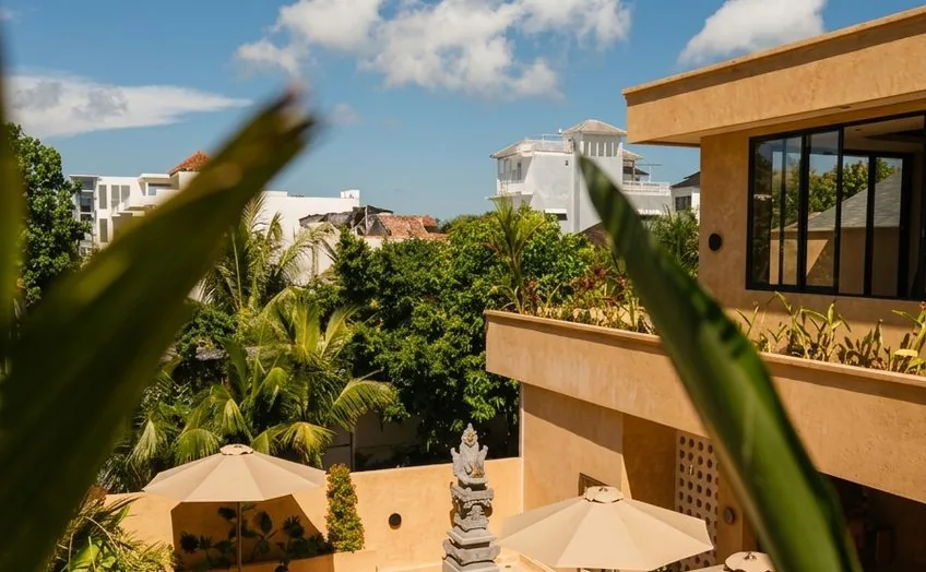 View of the villa courtyard through tropical plants